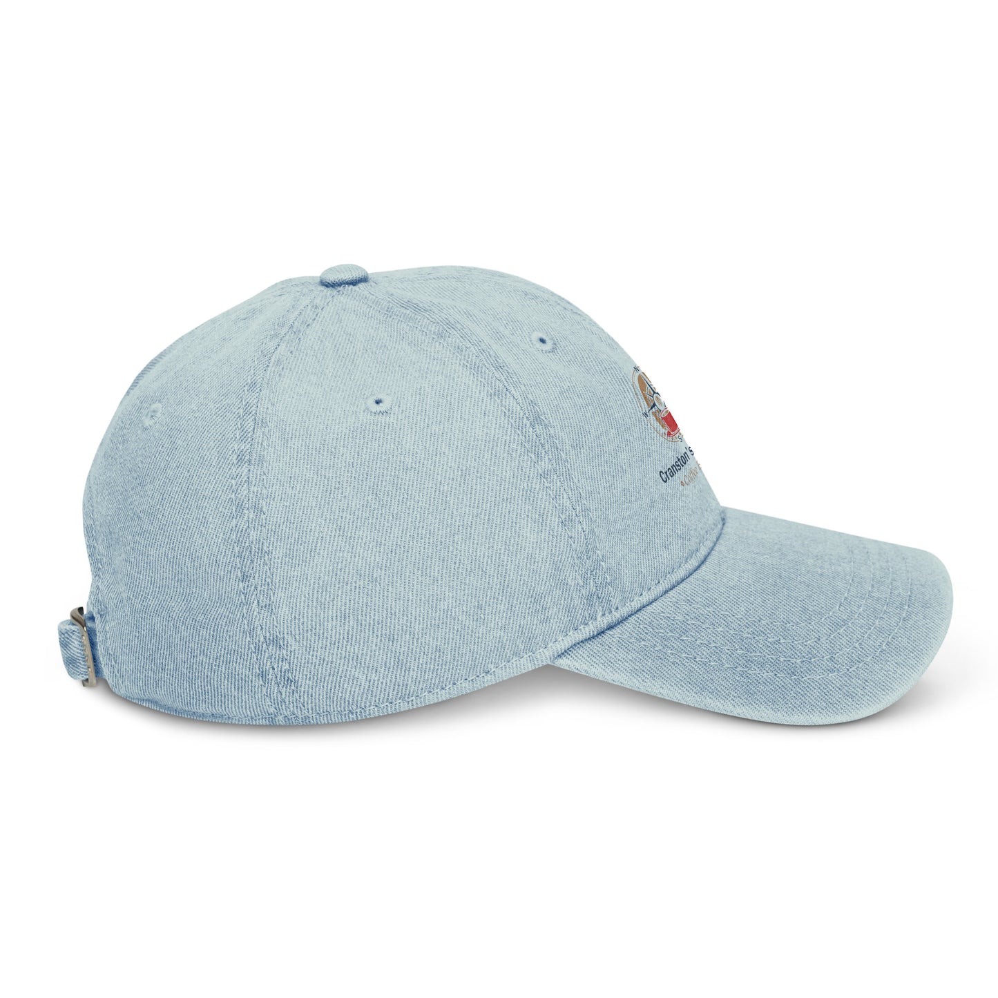 Light blue denim baseball cap side view with small embroidered patch and strap