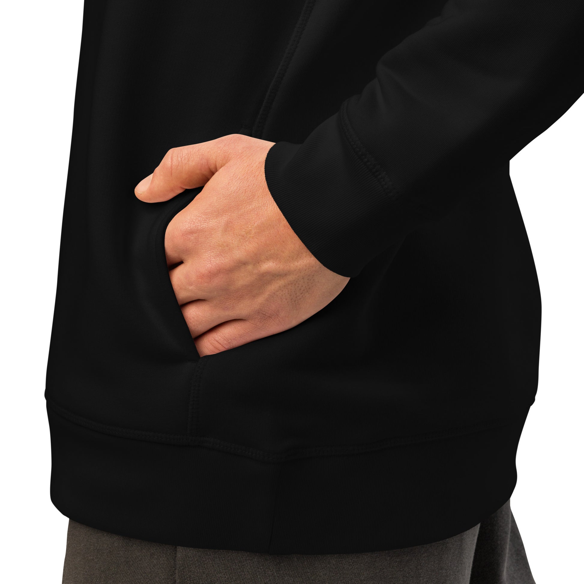 Black hoodie side pocket area with hand resting near the front hem