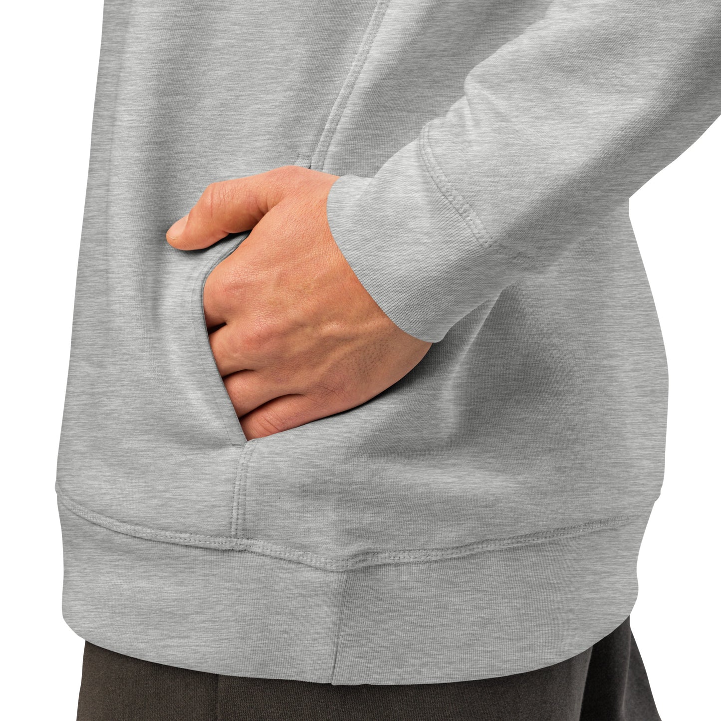 Heather grey hoodie side pocket area with hand resting near the front hem