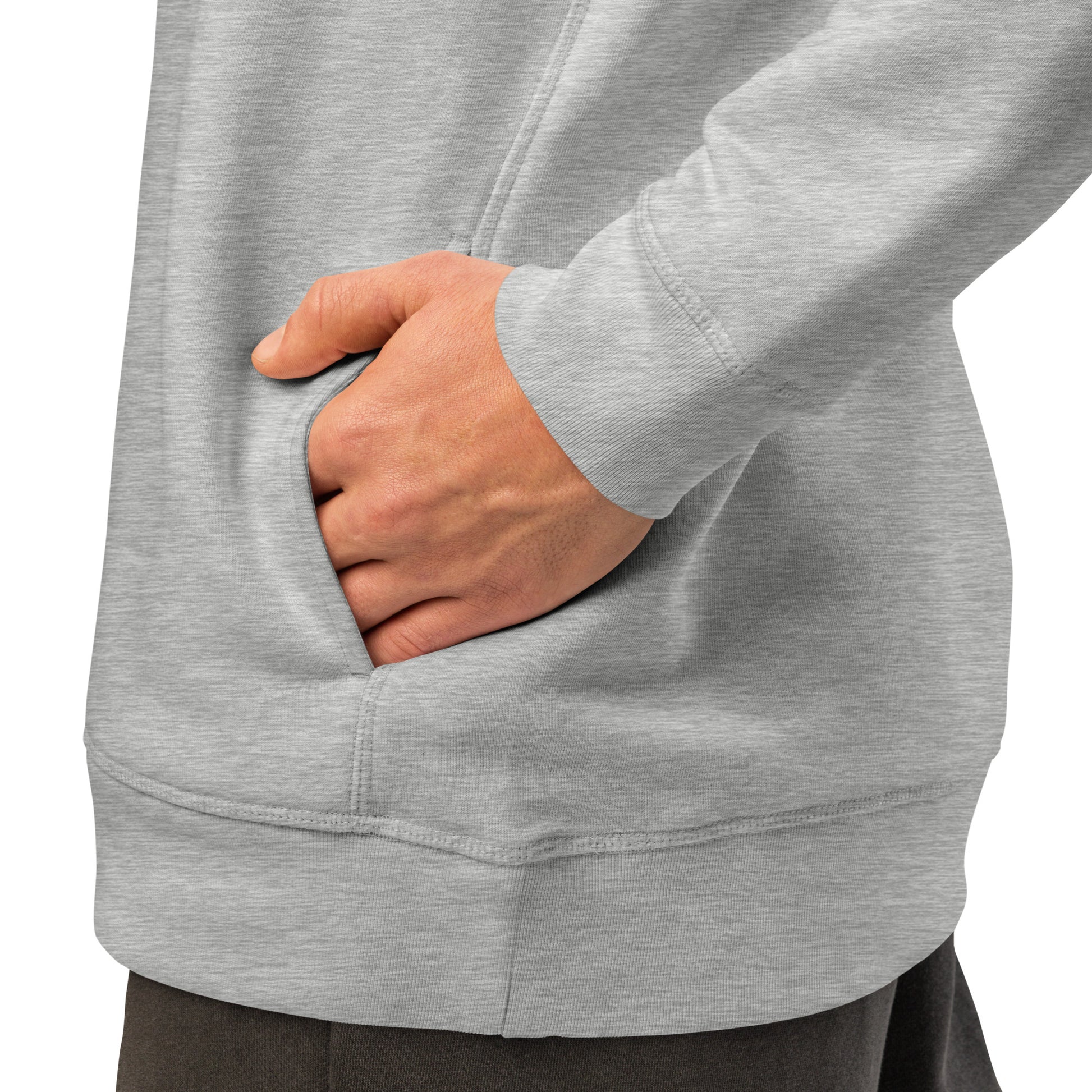 Heather grey hoodie side pocket area with hand resting near the front hem